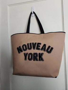 kate spade blush neoprene tote with black lettering